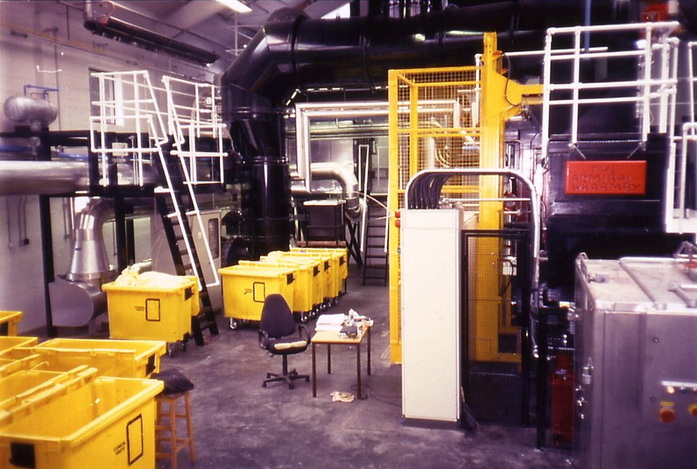 Incineration plant with yellow bins ready for waste disposal