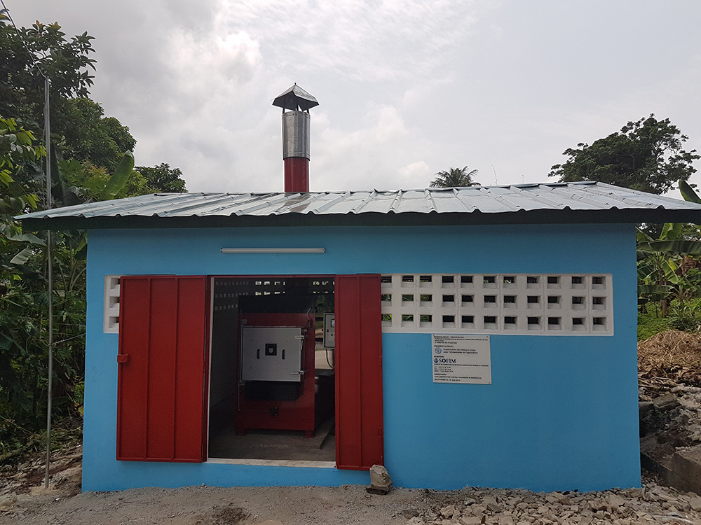 Red Medical incinerator in a blue hut