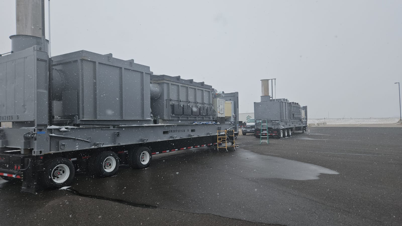 Two high capacity grey machines outside in snow