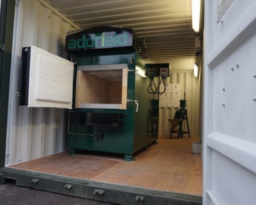 Green pet cremation machine housed in container