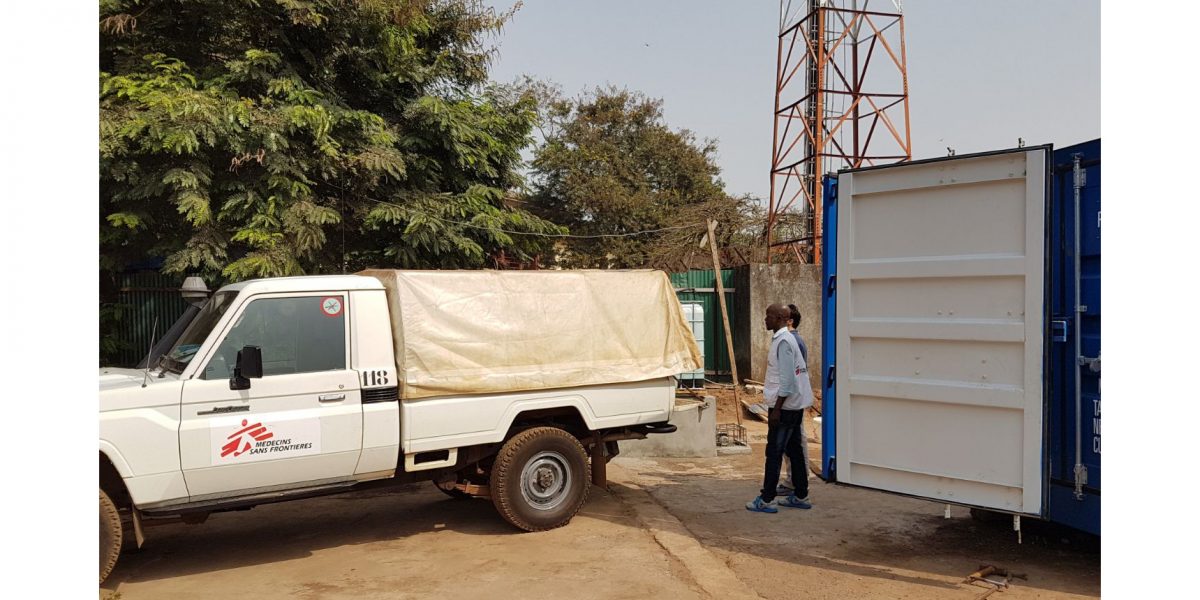 MSF delivery van next to blue container