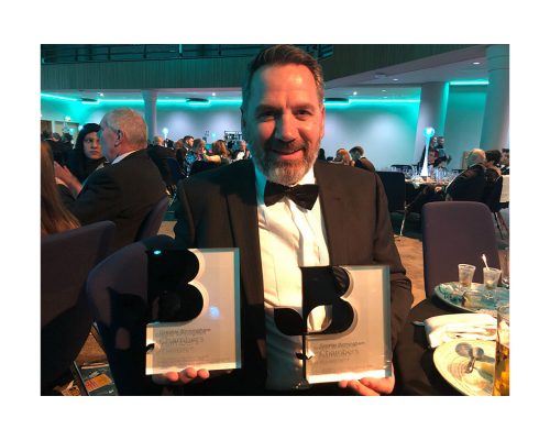 Steve Lloyd holding 2 Birmingham chamber of commerce awards