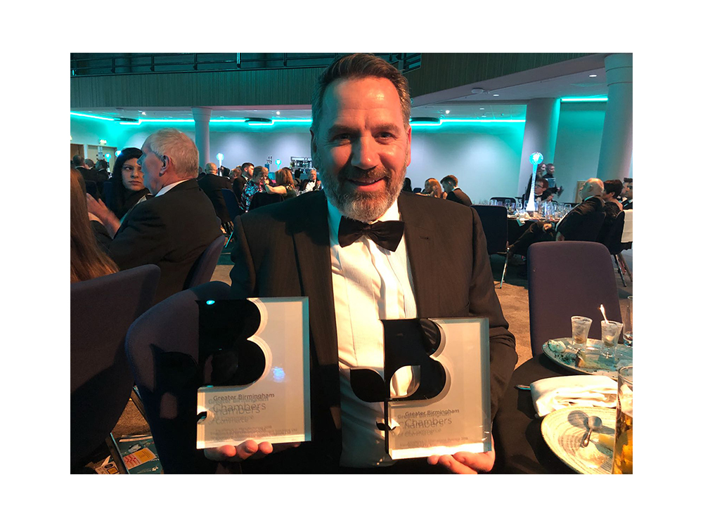 Steve Lloyd holding 2 Birmingham chamber of commerce awards