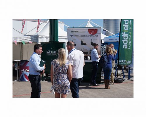 Sales staff talking to customers at pig and poultry show 2018