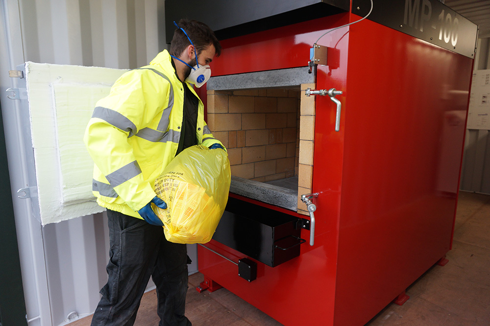 Loading an MP100 Medical waste incinerator with Yellow bag waste