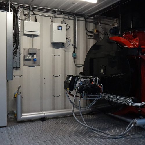 open container door showcasing red incinerator and control panel