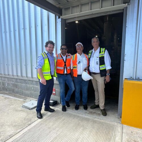 Four workers in PPE posing for photo