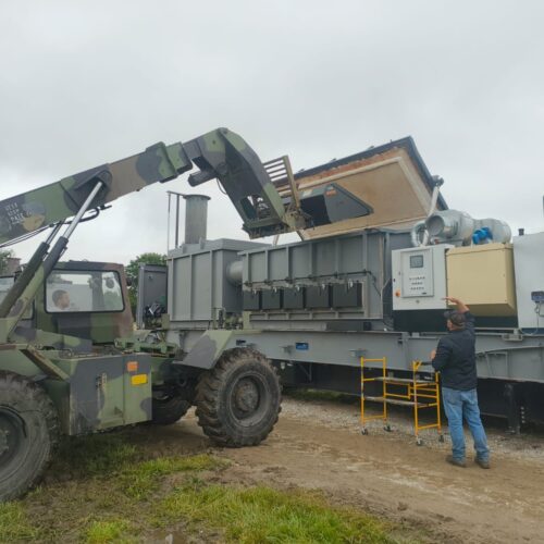 Loading a pig in a Rapid 1000 incinerator to maintain biosecurity.