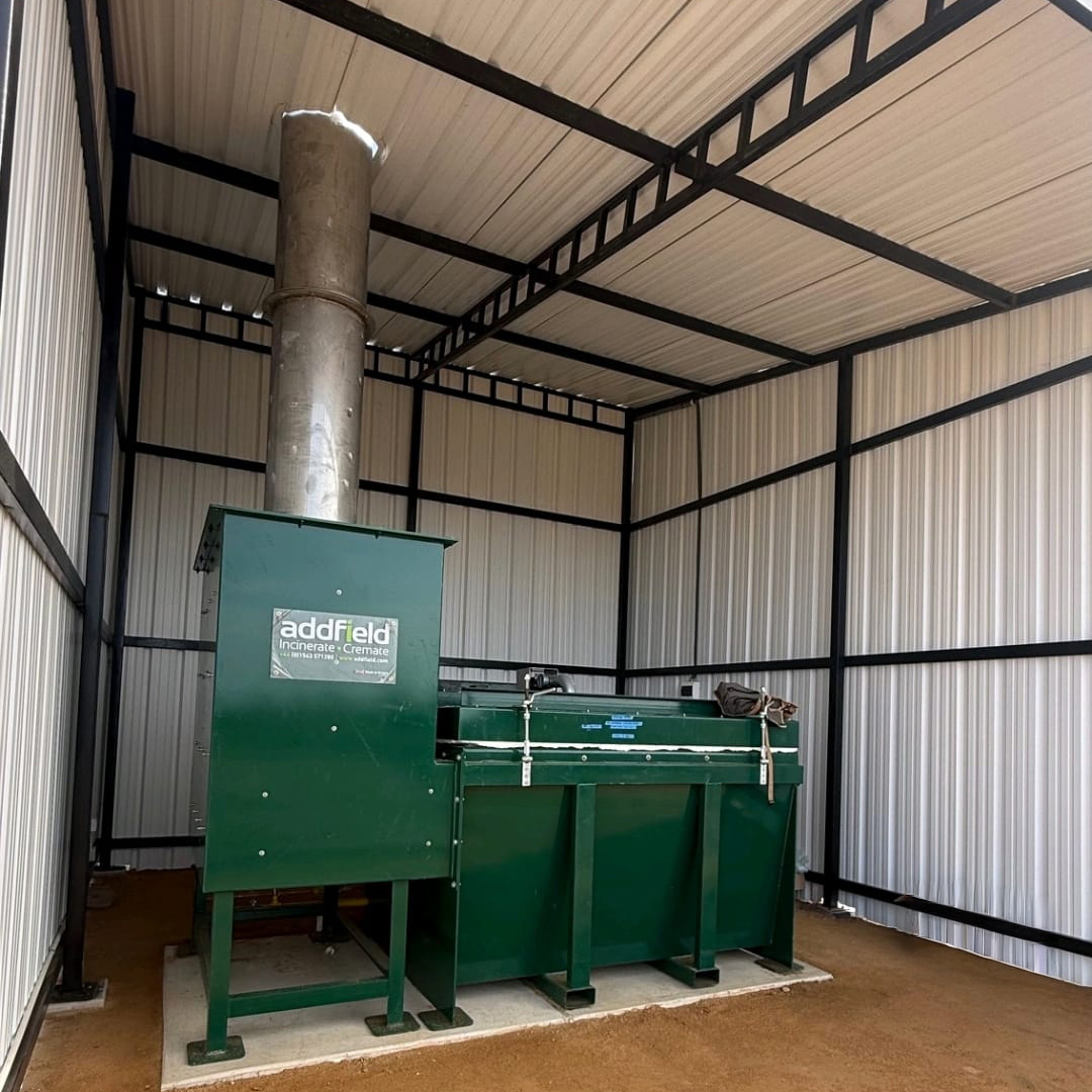 Green incinerator in a white semi permanent building